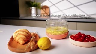 Glass food storage container with silicone